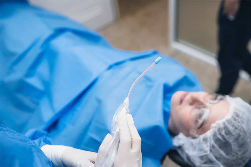 young woman sitting in dental chair at dental clinic before treatment